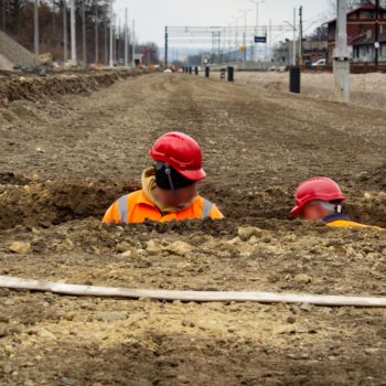 Zdjęcie: dwóch robotników pracuje w ziemi.